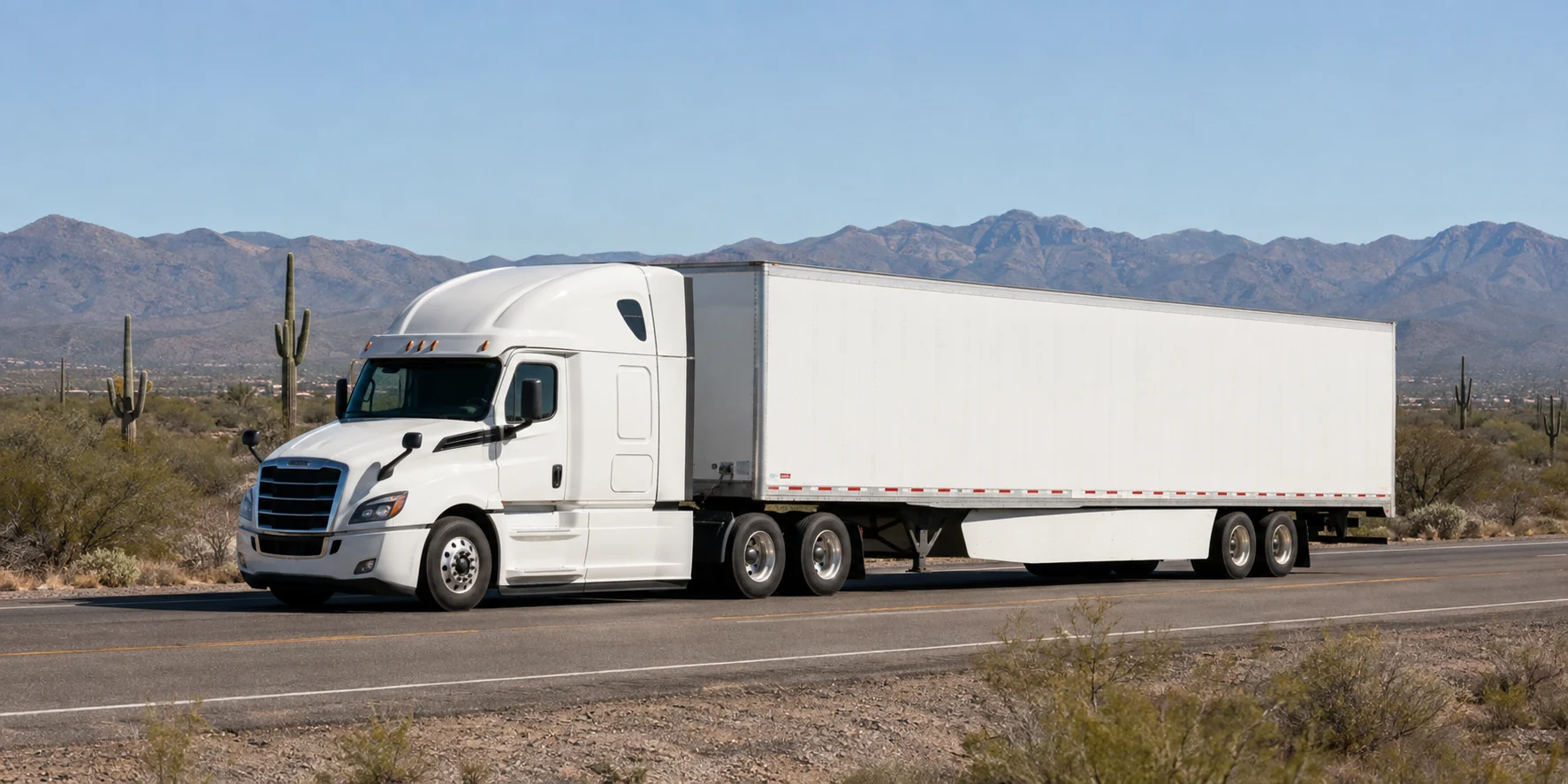 Unbranded white tractor-trailer on an industrial road near Tucson